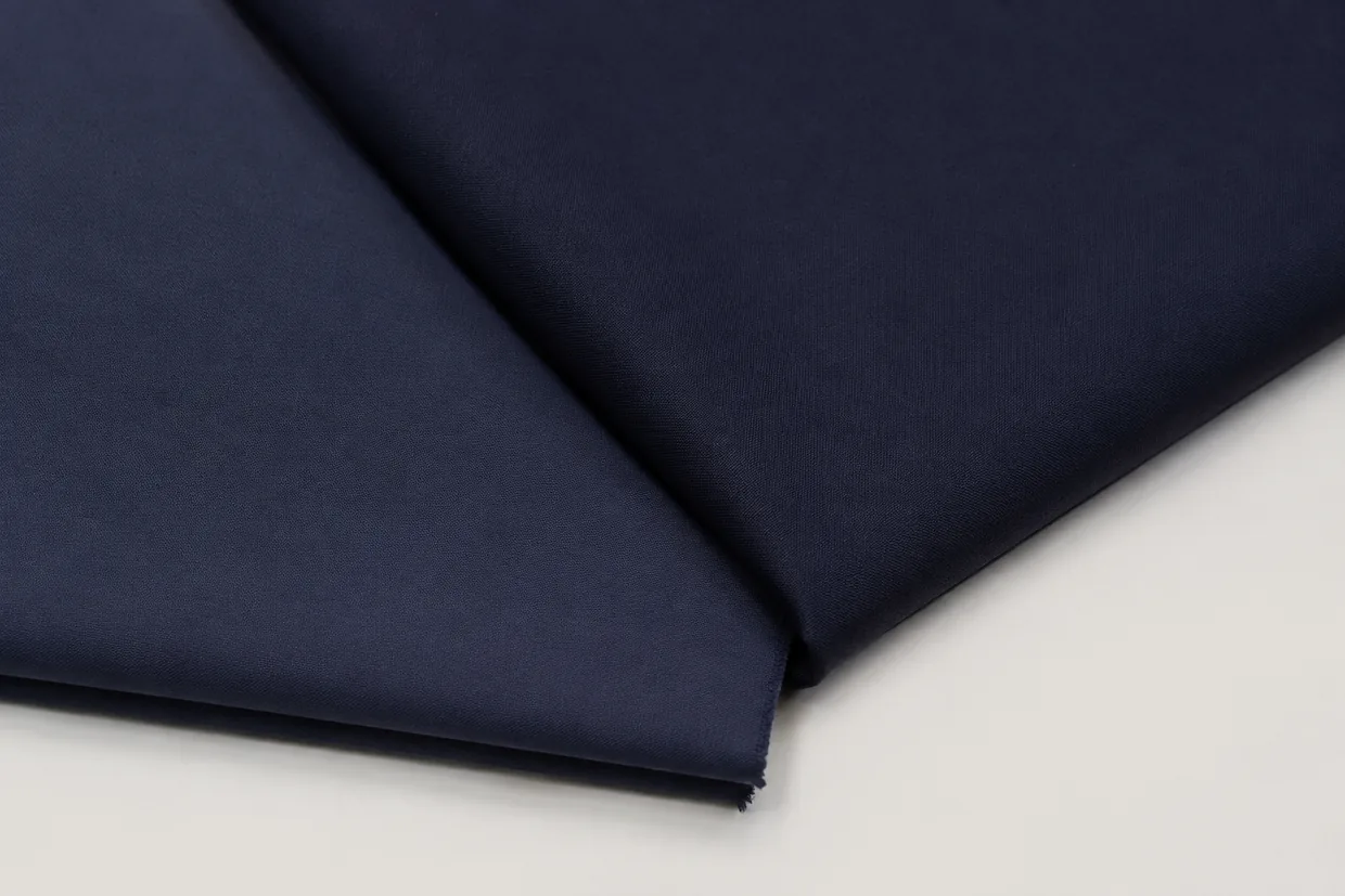 Two navy fabric pieces overlapping with a visible shade mismatch