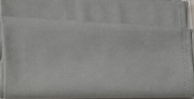 Folded B-Cotts Dhamaal, a piece-dyed 100% polyester suiting, in grey