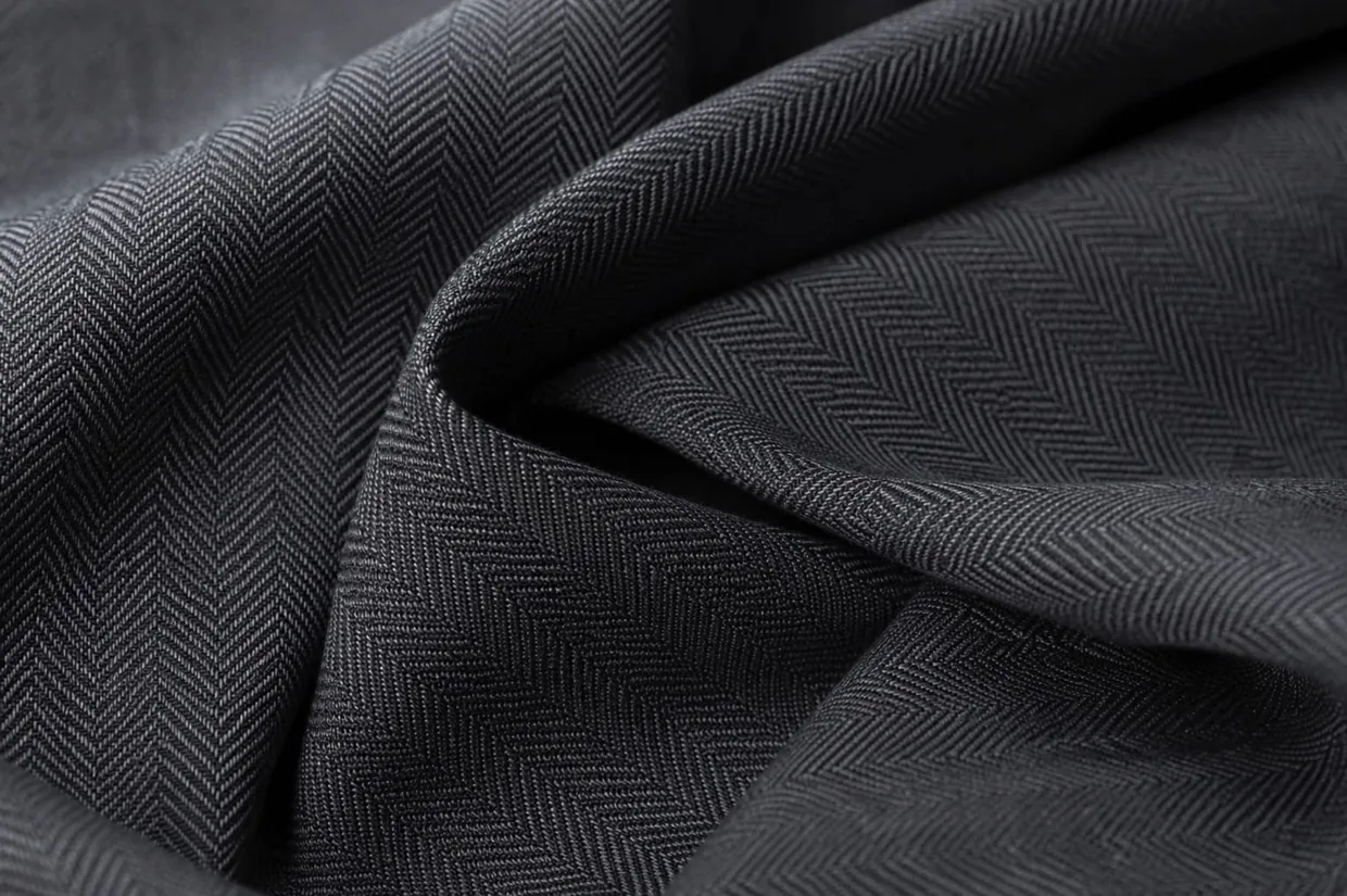 Charcoal herringbone suiting fabric close-up