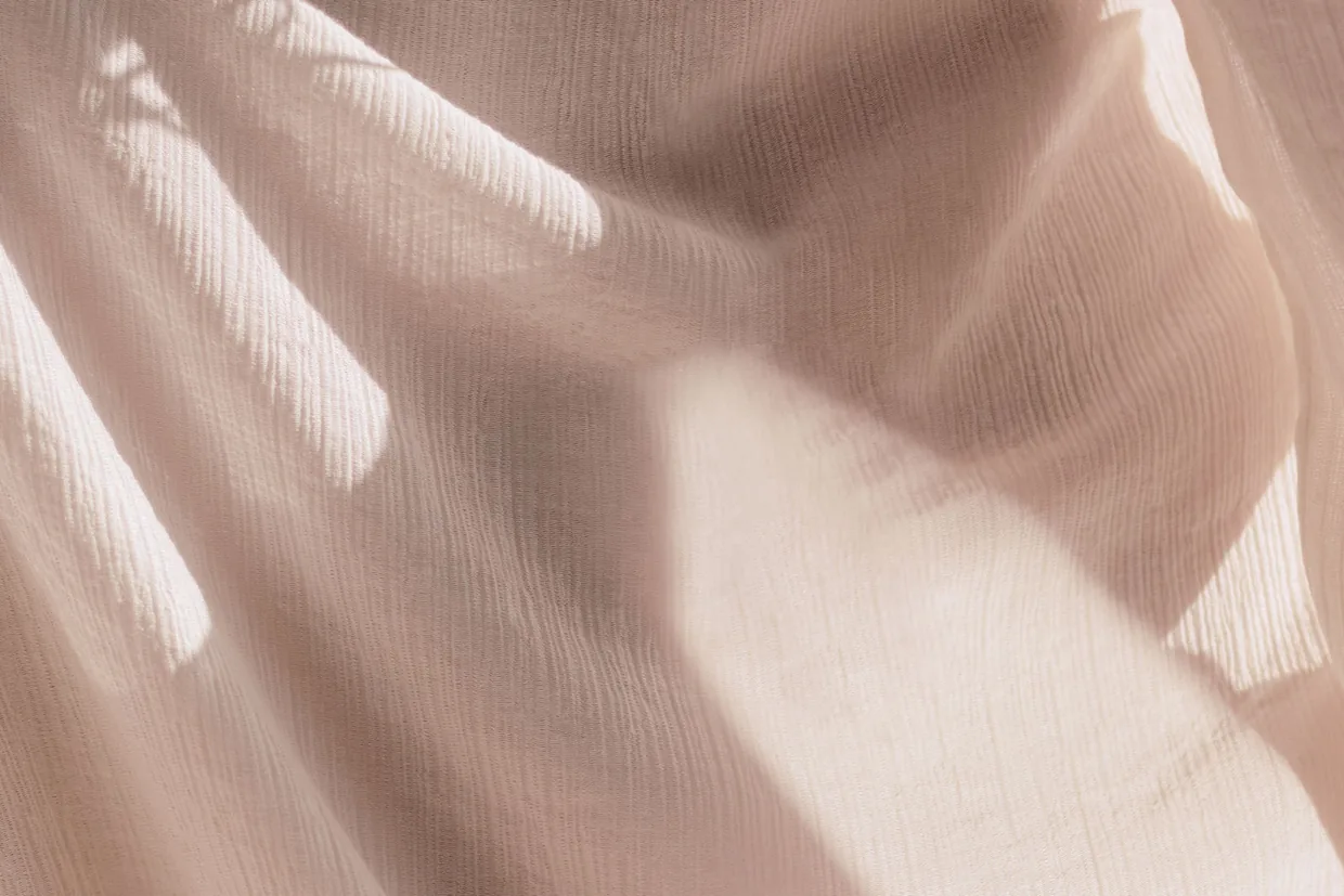 Close-up of draped poly-viscose uniform fabric showing weave texture and soft fall